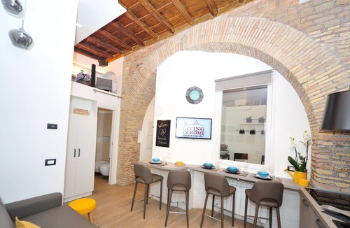 Trastevere Apartment | 17th-century apartment with beams and arches in Trastevere's iconic alley