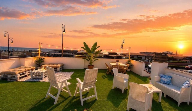Beachfront villa in Fiumicino, terrace & sunset